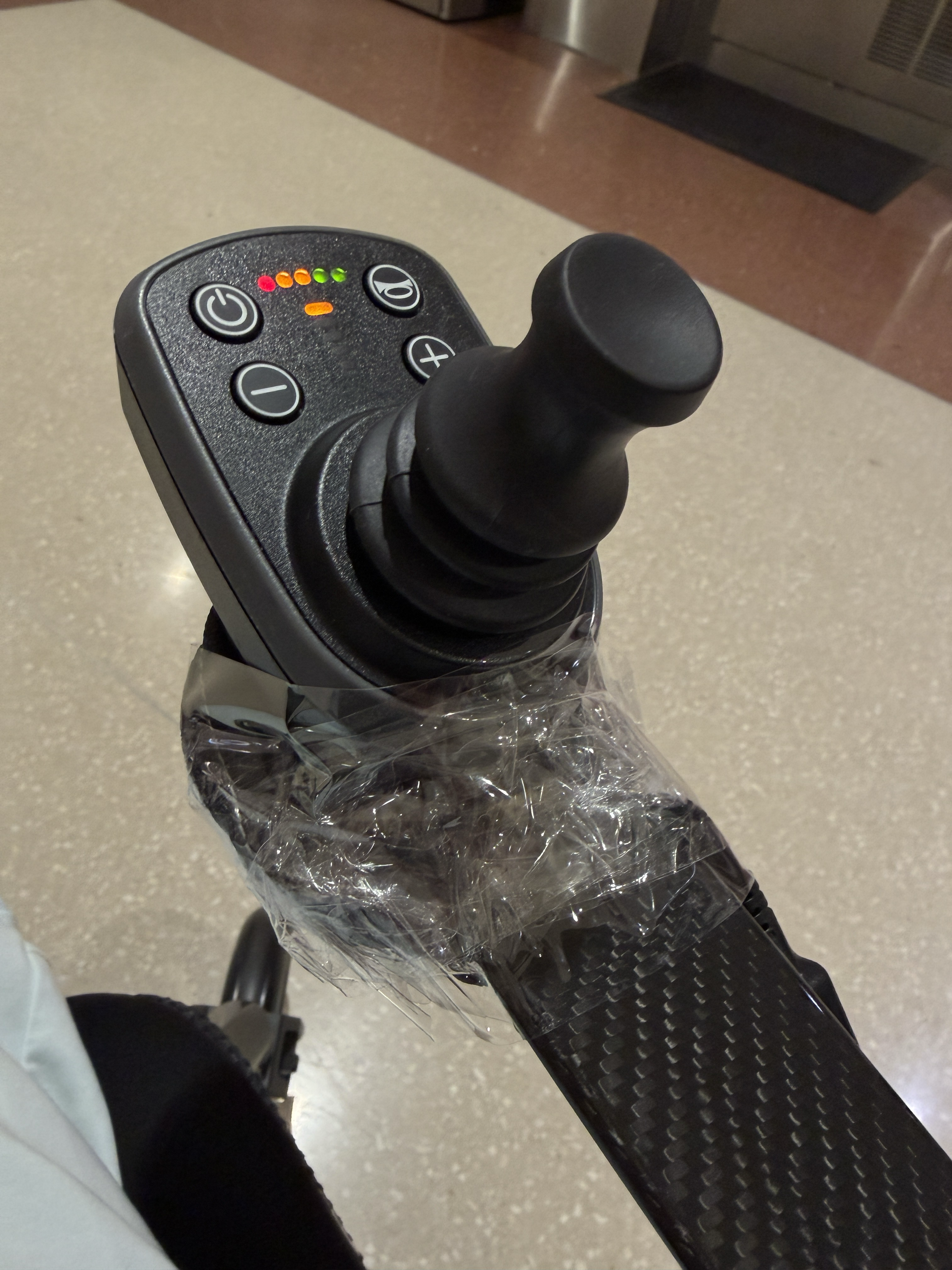 Close-up of a wheelchair joystick snapped during air travel.